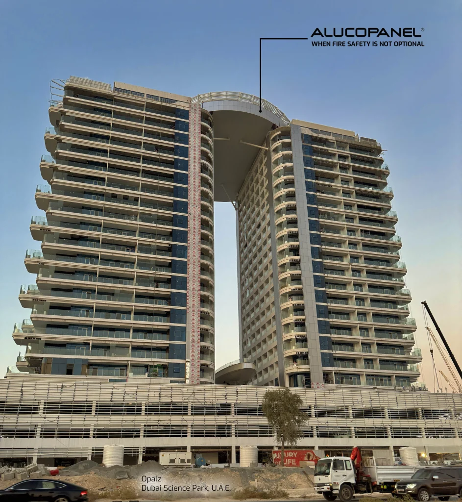 Opalz Residential Towers illuminated at dusk, emphasizing the modern design and fire-safe Alucopanel® A2 cladding.