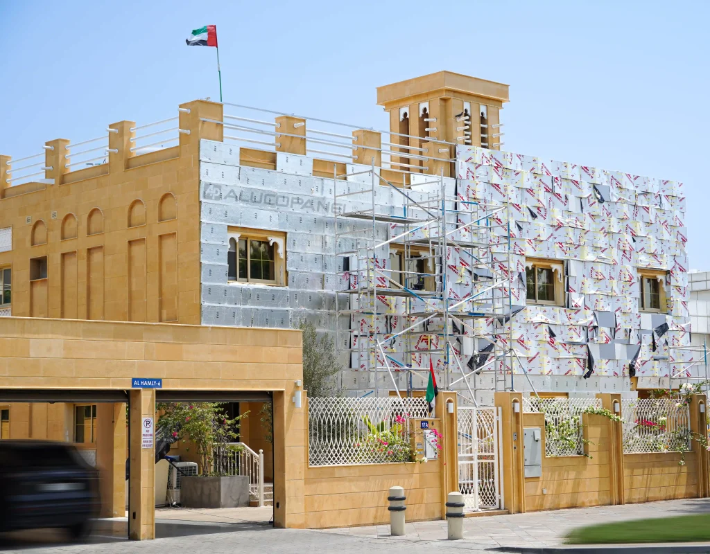 Full view of Arabic villa facade renovation with Alucopanel cladding and scaffolding on Al Hamly street Dubai