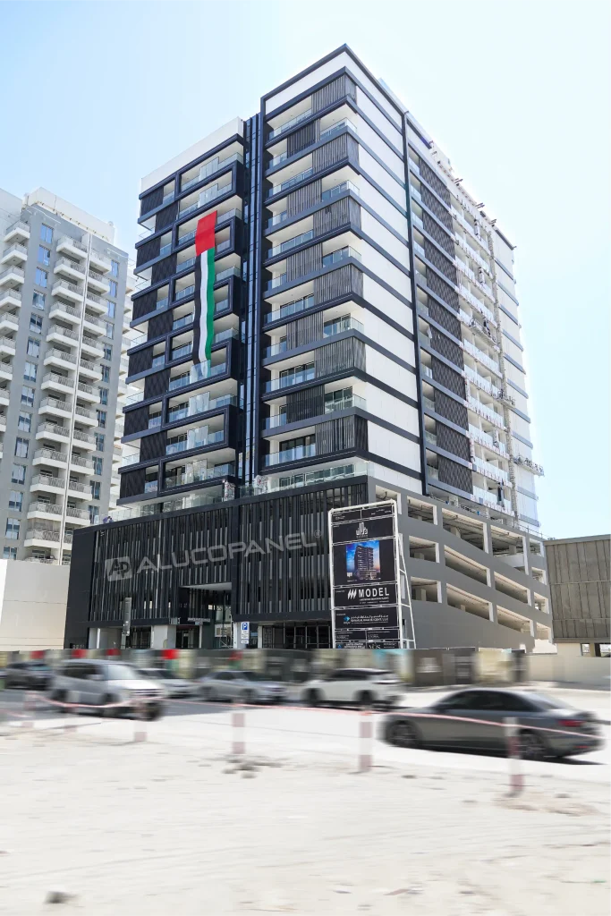 Full elevation of Gharbi Residences Dubai showing Alucopanel ACP facade cladding and louvered podium